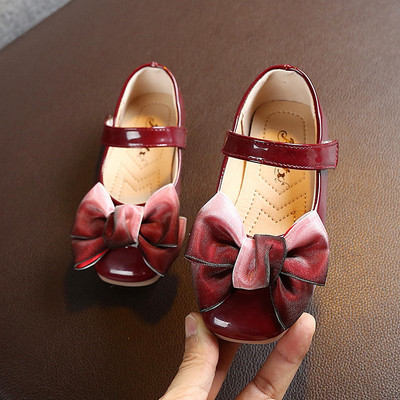 Children`s modern shoes in four colors with a ribbon