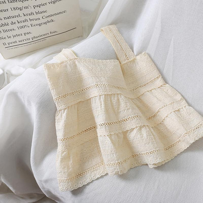 Modern női felső, vastag pántokkal, fehér és bézs színben