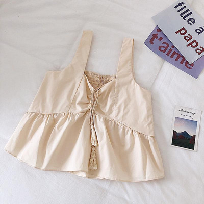 Modern női felső, bojttal és vastag pántokkal