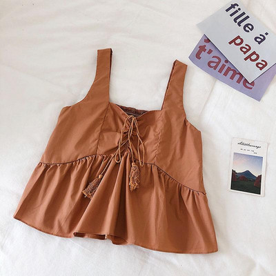 Modern női felső, bojttal és vastag pántokkal