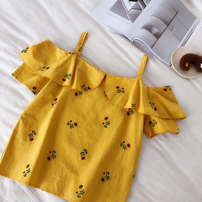 Modern női felső, fehér és kék hímzéssel