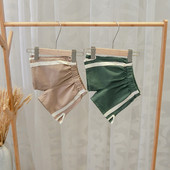 Alkalmi gyereknadrág fiúknak zöld és barna szegéllyel