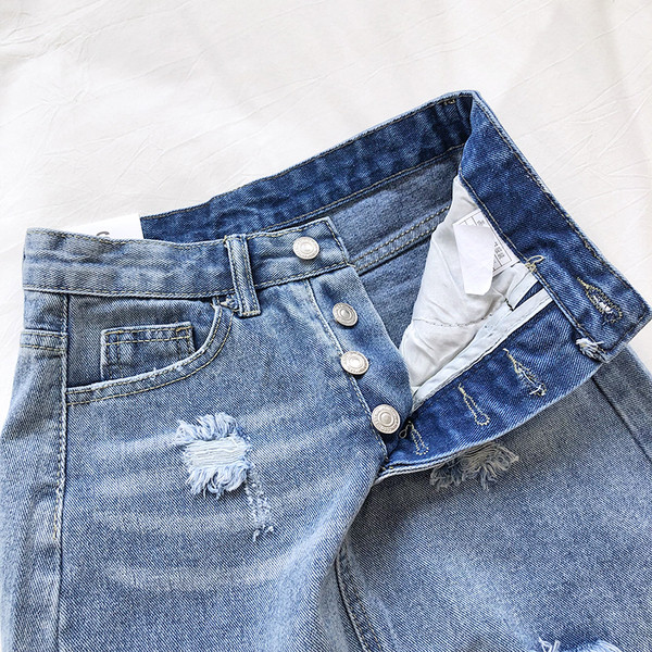 Női farmerszoknya magas derékkal, szakadt motívumokkal