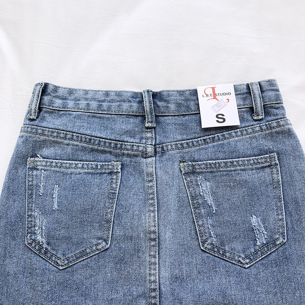 Női farmerszoknya magas derékkal, szakadt motívumokkal