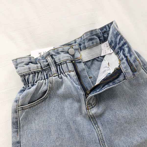 Naprakész női farmerszoknya, magas derékkal, szakadt motívumokkal