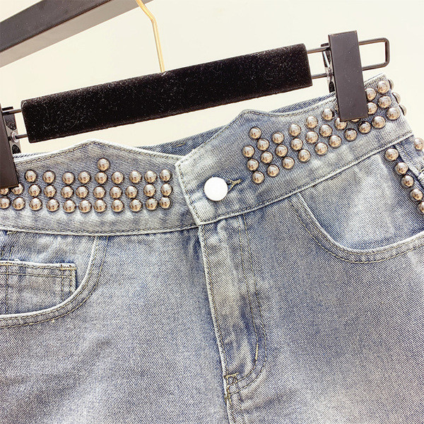 Pantaloni de damă moderni din denim cu decor cu ochiuri