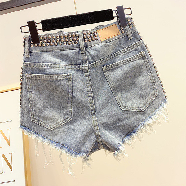 Pantaloni de damă moderni din denim cu decor cu ochiuri