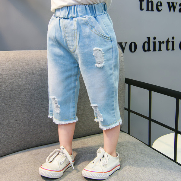 Szakadt motívumokkal és zsebekkel ellátott gyerekfarmer - lányoknak