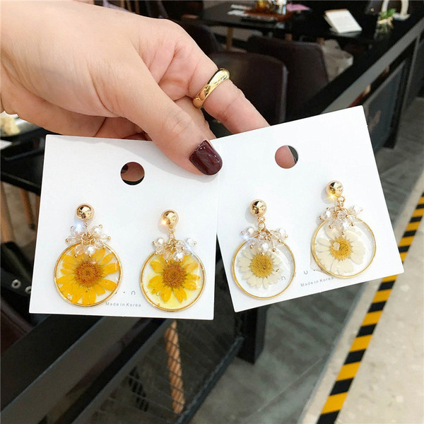 Fehér és sárga női fülbevaló gyöngyökkel