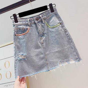 Női farmerszoknya szakadt motívumokkal, kék színben