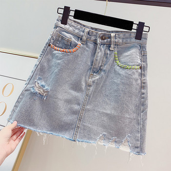 Női farmerszoknya szakadt motívumokkal, kék színben