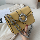 Stílusos kézitáska csattal és díszítő kövekkel