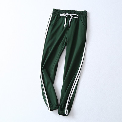 pantaloni sport de damă în negru și verde cu margini laterale