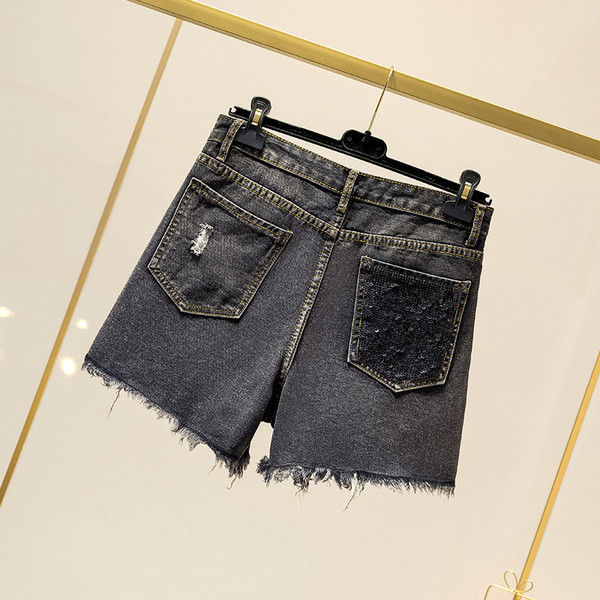 Pantaloni scurți de damă din denim cu paiete și motive rupte