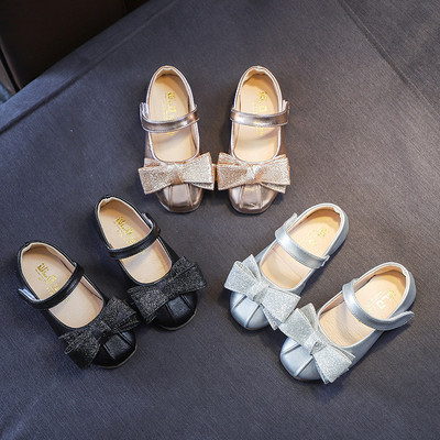 Stylish children`s shoes in three colors with a ribbon
