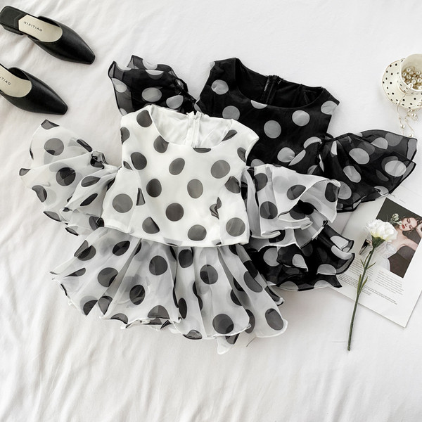 Bluză de damă cu buline cu fermoar în alb și negru