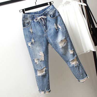 Casual women`s jeans 7/8 length with torn motifs