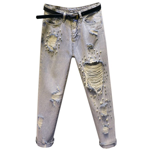 Aktuális női farmer szakadt motívumokkal, díszítőgyöngyökkel