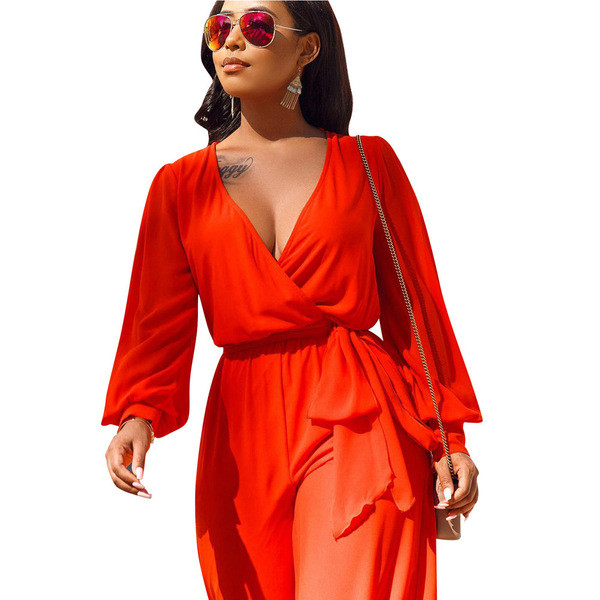 Salopetă de damă elegantă, cu decolteu adânc și mâneci lungi, de culoare portocalie