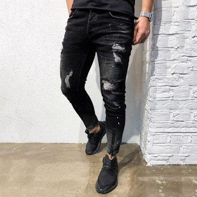 Modern men`s long jeans with torn motifs in black