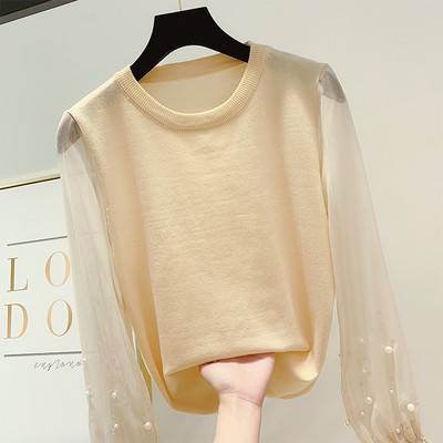 Különböző színekben gyöngyökkel díszített modern női pulóver