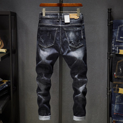 Current men`s jeans with pockets and torn motifs