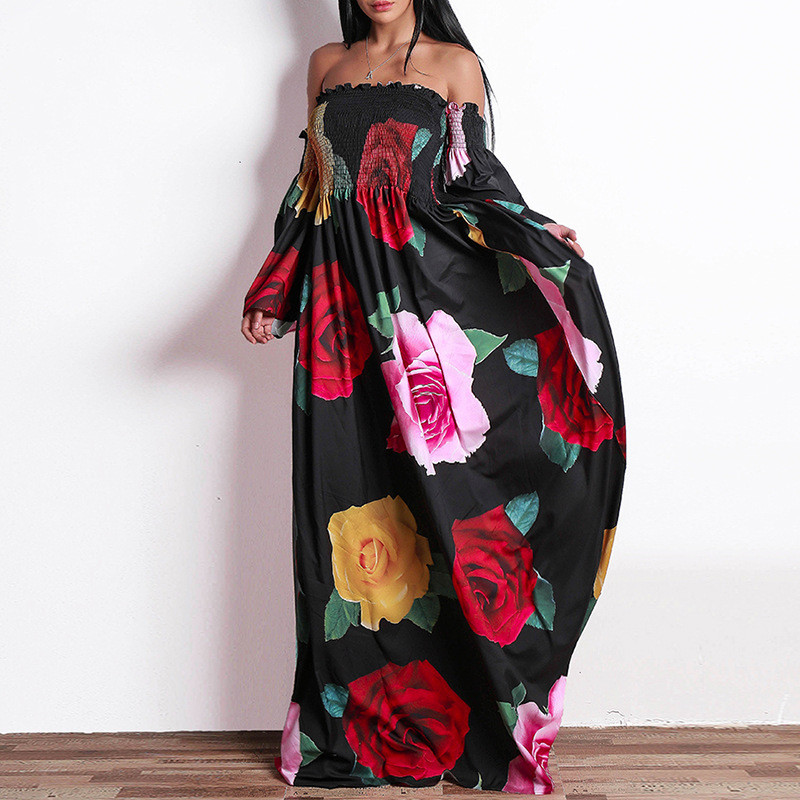 Modern women`s long dress with dropped sleeves and floral pattern in black and white