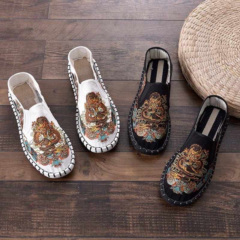 Modern women`s moccasins with colored embroidery and a flat sole in two colors