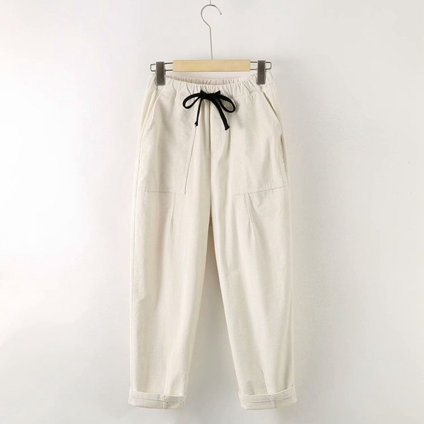 Modern női nadrág zsebekkel és nyakkendőkkel - széles modell