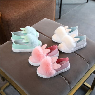 Children`s shoes with down and rabbit ears in white, pink and mint color