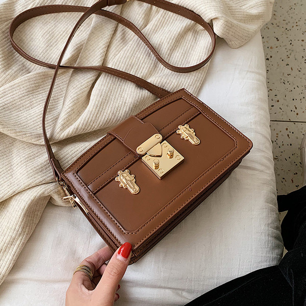 Modern női táska fém elemmel, hosszú fogantyúval