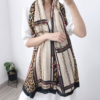 Autumn women`s scarf with colored pattern in brown and beige