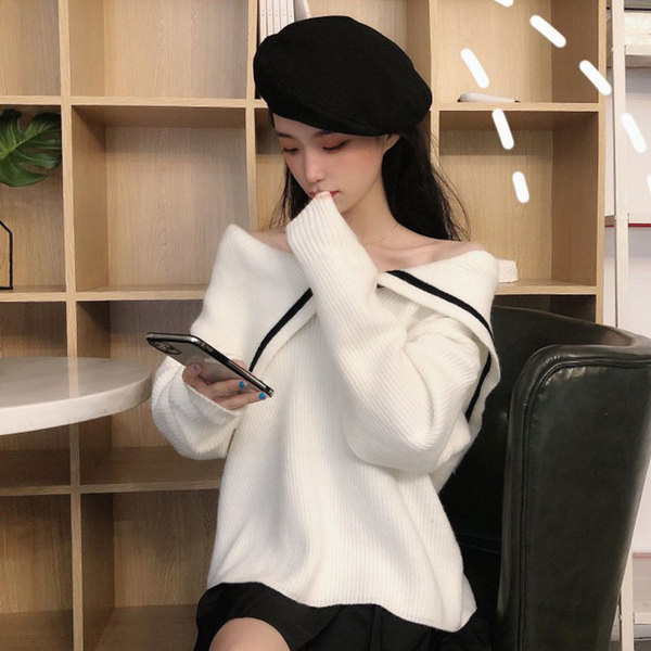 Γυναικεία κορυφαία πλεκτή μπλούζα σε λευκό και μαύρο χρώμα με μανίκια πτώσης