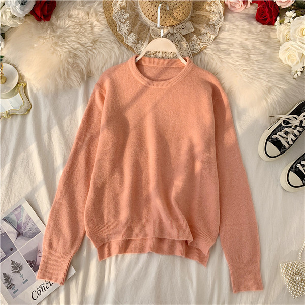 Modern női pulóver ovális nyakkivágással, aszimmetrikus mintával