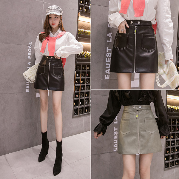 Női bőrszoknya cipzárral és zsebekkel fekete és zöld színben