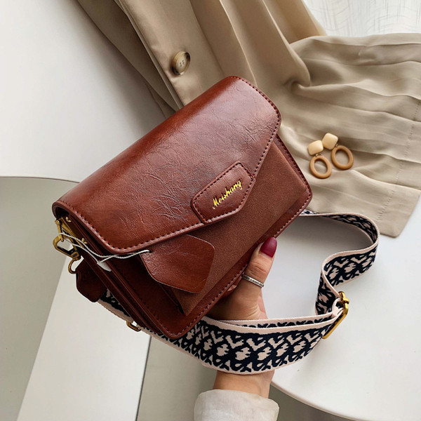 Női táska hosszú füllel fekete, kék, zöld és barna színekben