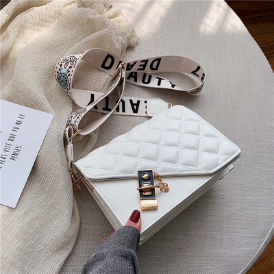 Modern női táska hosszú mintás fogantyúval, fém elemekkel