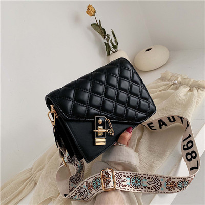 Modern női táska hosszú mintás fogantyúval, fém elemekkel