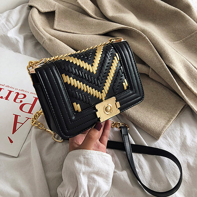 Stílusos kézitáska fém elemekkel és hosszú fogantyúval