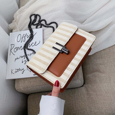 Μοντέρνα γυναικεία τσάντα με μεταλλικό συνδετήρα και μεγάλη λαβή