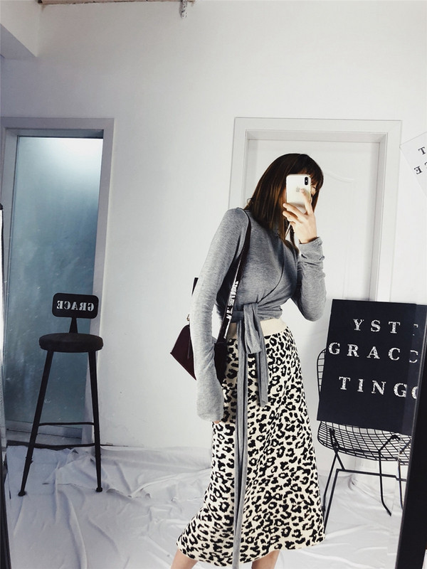 Σύντομο γυναικείο πουλόβερ με υψηλό κολάρο και κορδόνι στη μέση