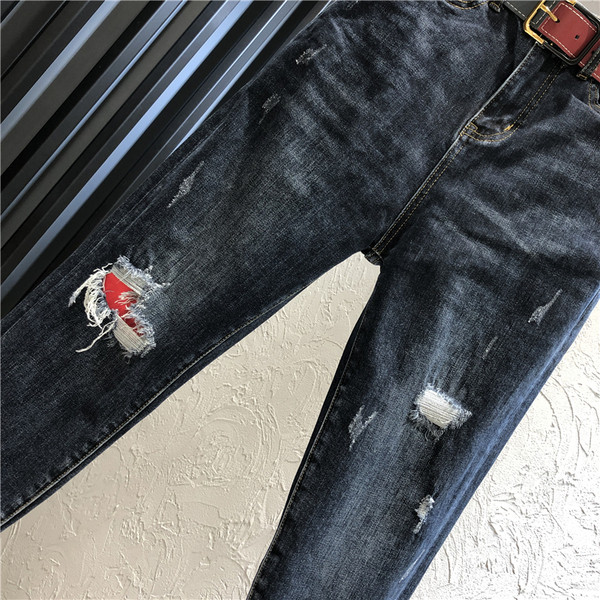 Alkalmi női hosszú farmernadrág magas derékkal, szakadt motívummal