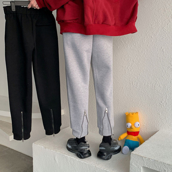 Pantaloni sport de damă, de culoare gri și negru, cu fermoar