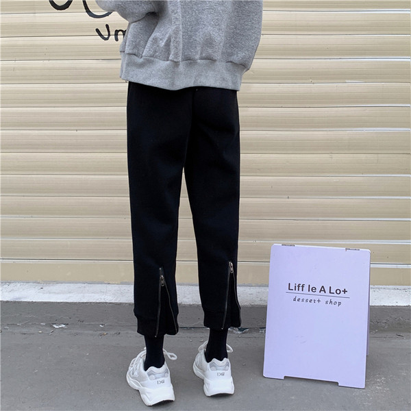 Pantaloni sport de damă, de culoare gri și negru, cu fermoar