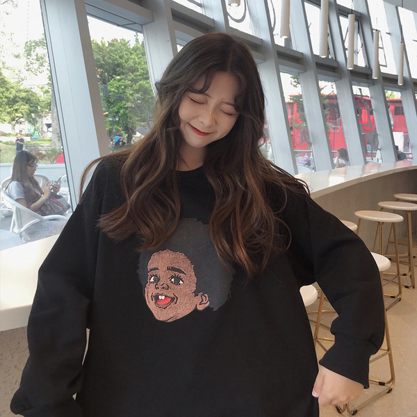 Μοντέρνα γυναικεία μπλούζα με εφαρμογές και στρογγυλη λαιμόκοψη σε μαύρο χρώμα