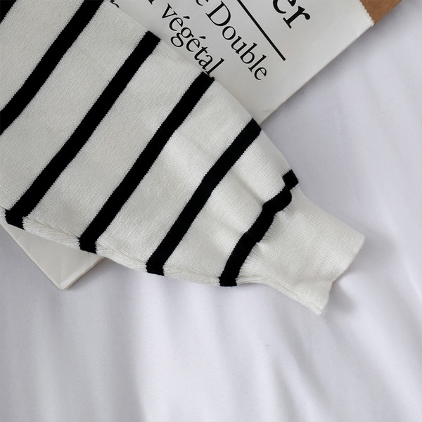 Casual γυναικείο πουλόβερ με τσέπες σε λευκό και μαύρο χρώμα