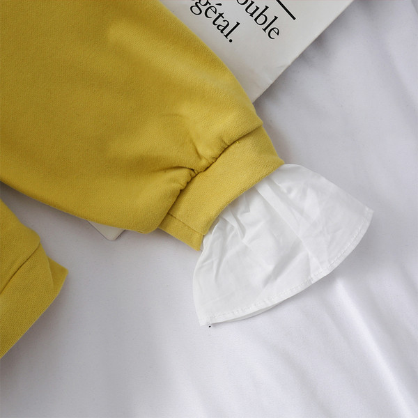 Μοντέρνα γυναικεία μπλούζα σε μαύρο και κίτρινο χρώμα με μακριά μανίκια και γιακά