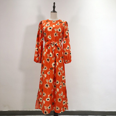 Hosszú ruha szabású modell narancssárga színben, virágmintával