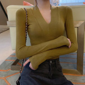 Vékony kötésből készült női testhezálló blúz spitz nyakkivágással