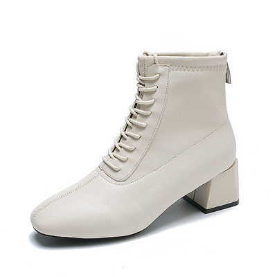 Μοντέρνες γυναικείες μπότες με κορδόνια και φερμουάρ σε λευκό και μαύρο χρώμα